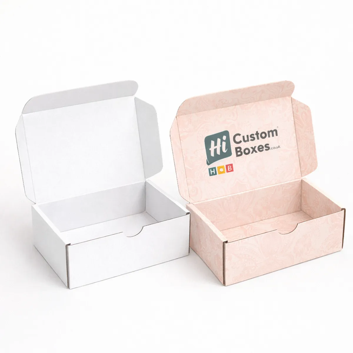 Two small cardboard mailer boxes with hinged lids- one plain white and one patterned pink- class=